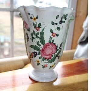 Vintage hand-painted ceramic vase with floral decorations.